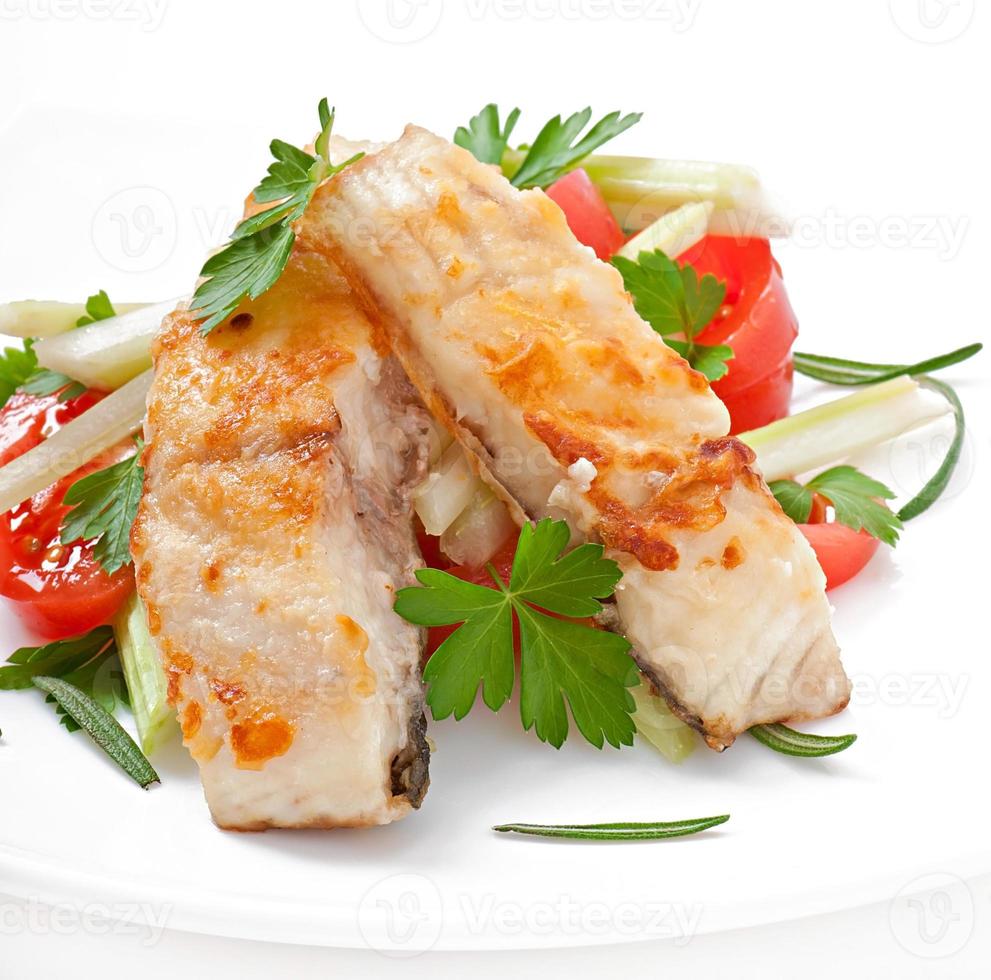 Fried filet fish and fresh vegetable salad photo