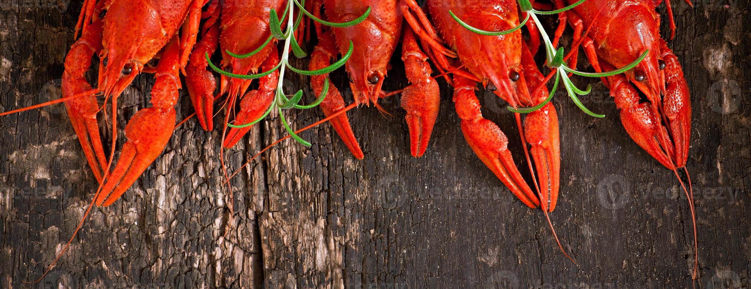 Fresh boiled crawfish on the old wooden background photo