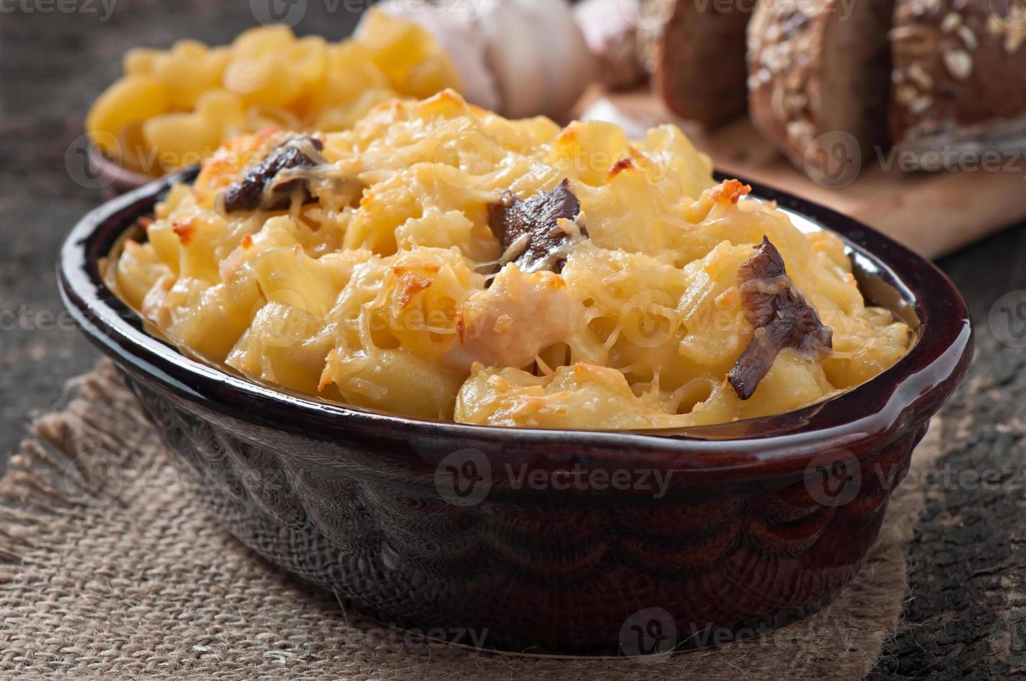 Macaroni with cheese, chicken and mushrooms baked in the oven photo