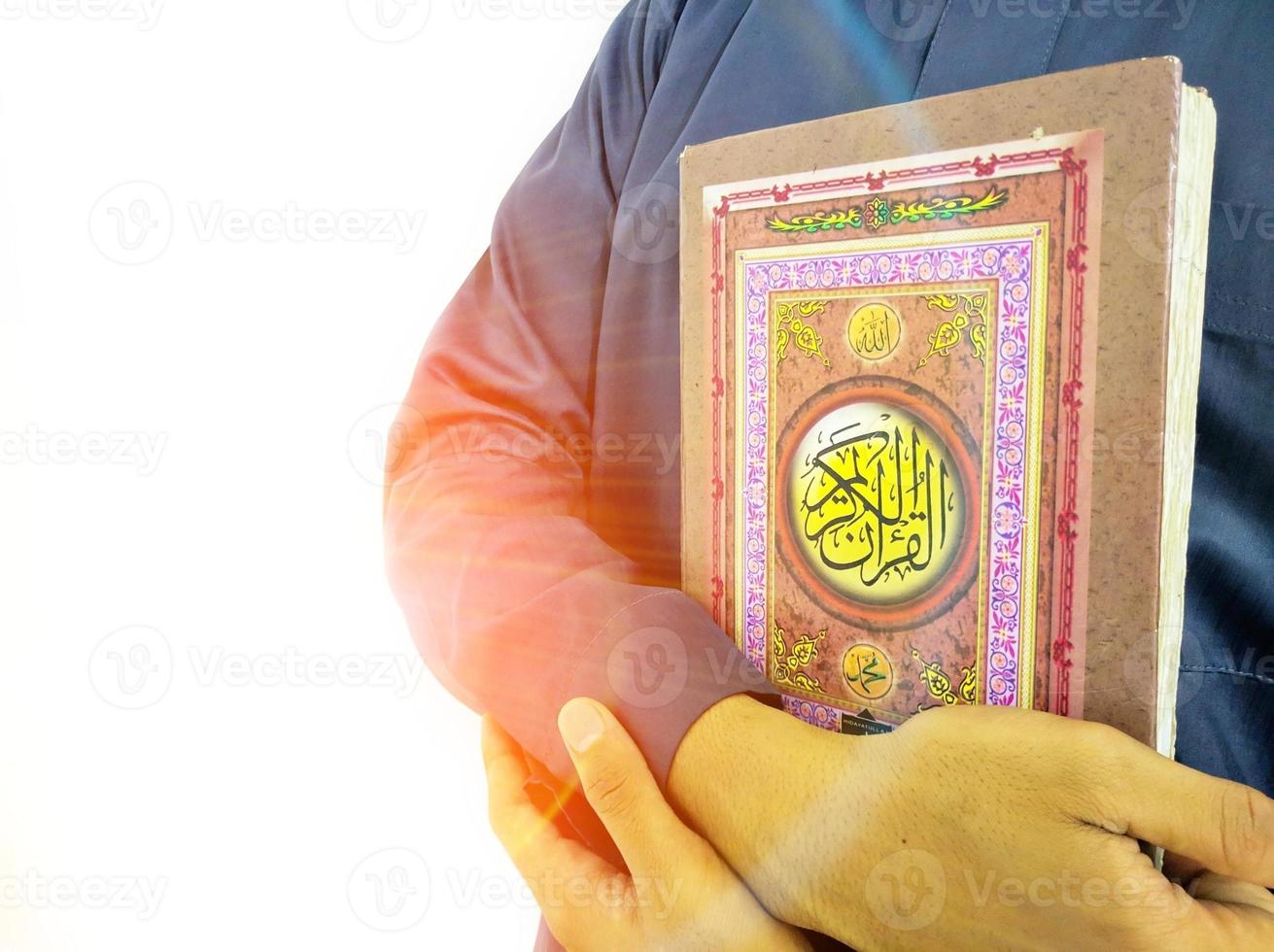 Man Holding and reading quran. Islamic Background photo