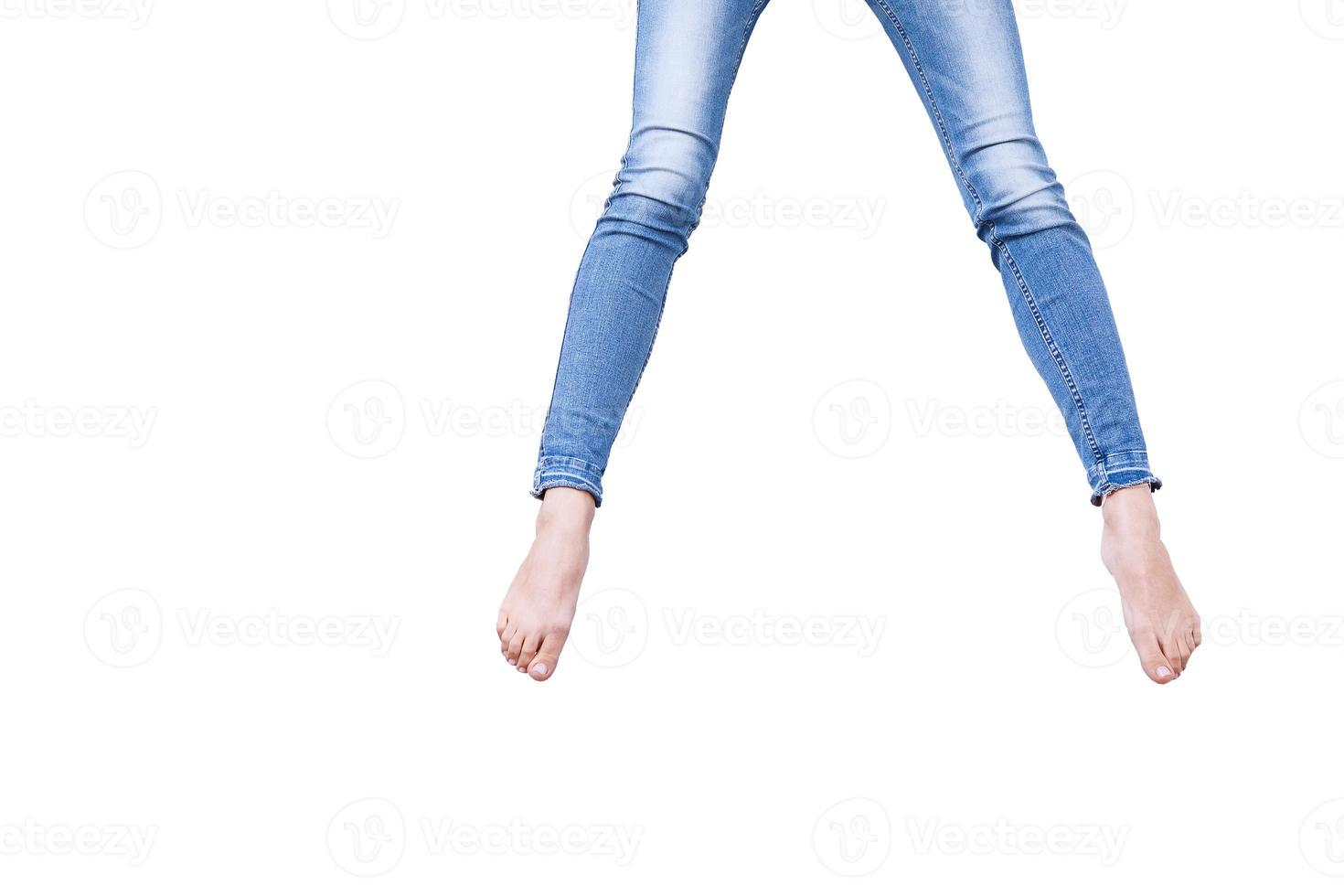 Female legs in jeans isolated on white. Copy space and mock up. photo