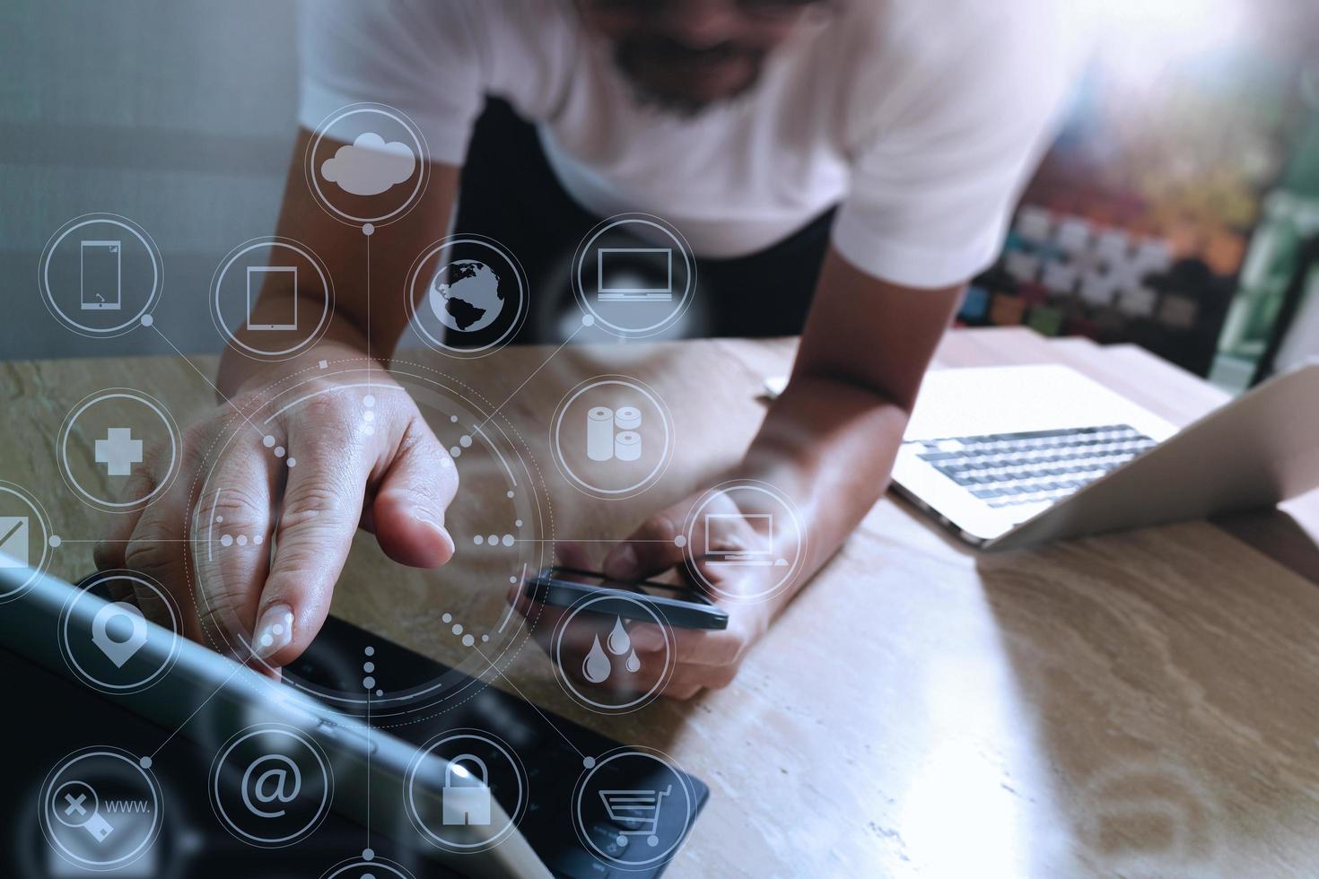 Designer hand using mobile payments online shopping,omni channel,in modern office wooden desk,icons graphic interface screen,eyeglass,filter photo