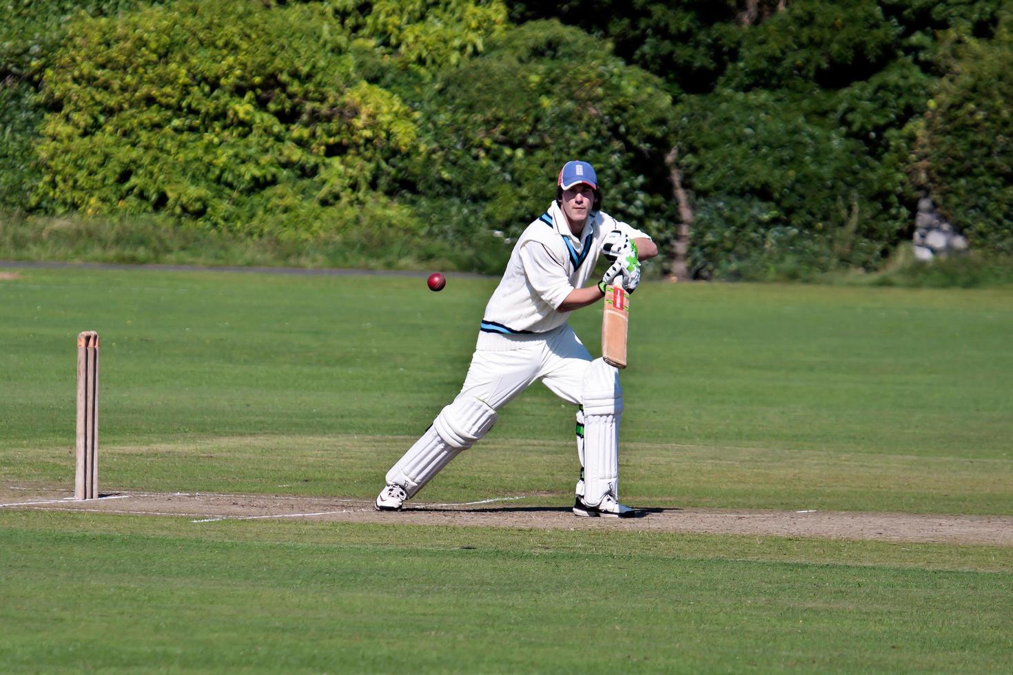 BAMBURGH, NORTHUMBERLAND, UK, 2010.  Playing Cricket on the Green photo