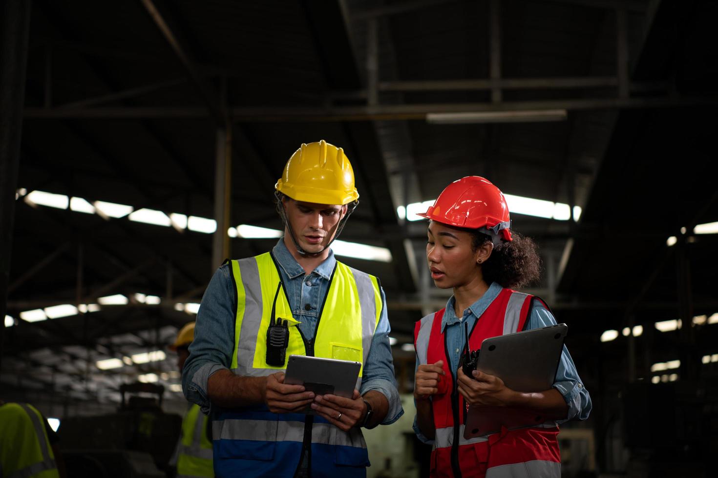 The foreign chief engineer came to inspect the old mechanical factory. There is an African female mechanic explaining details and progress reports photo