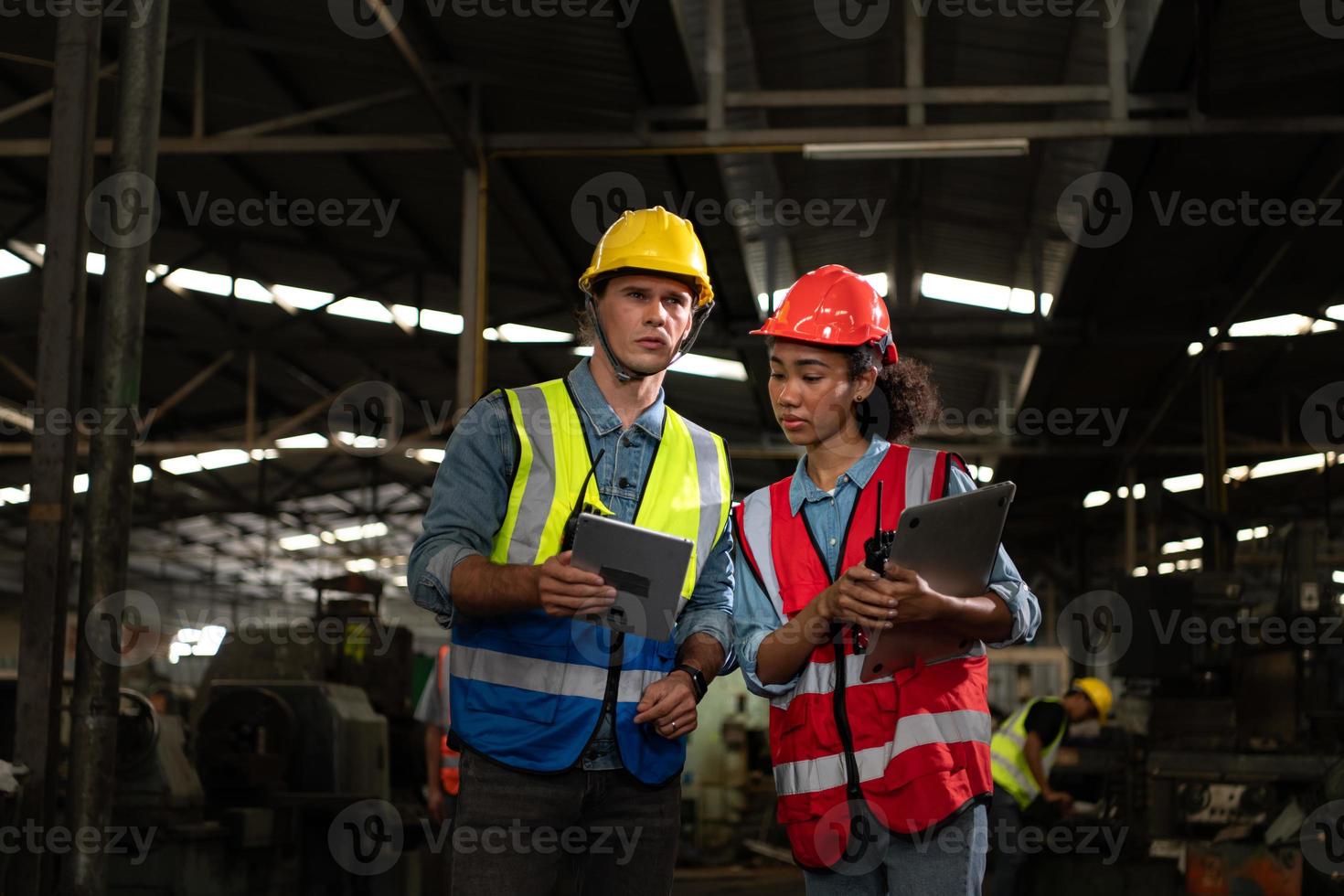 The foreign chief engineer came to inspect the old mechanical factory. There is an African female mechanic explaining details and progress reports photo