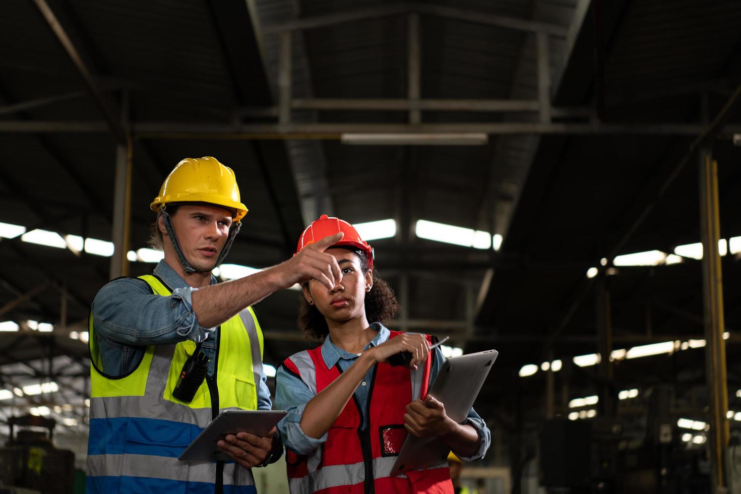 The foreign chief engineer came to inspect the old mechanical factory. There is an African female mechanic explaining details and progress reports photo