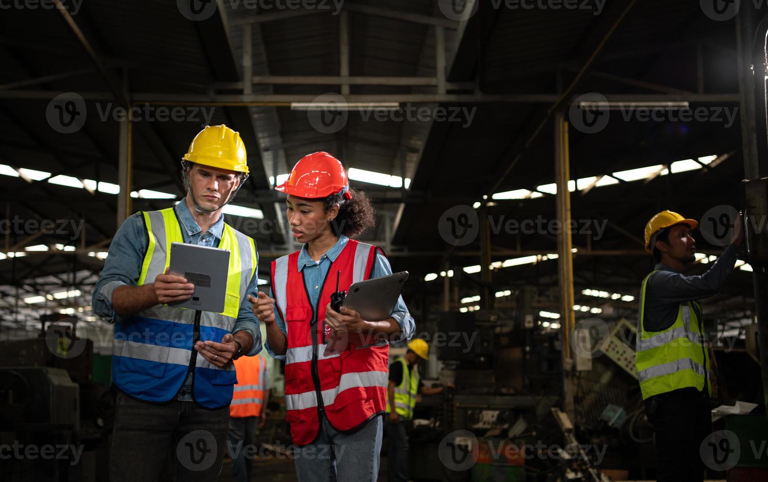 The foreign chief engineer came to inspect the old mechanical factory. There is an African female mechanic explaining details and progress reports photo