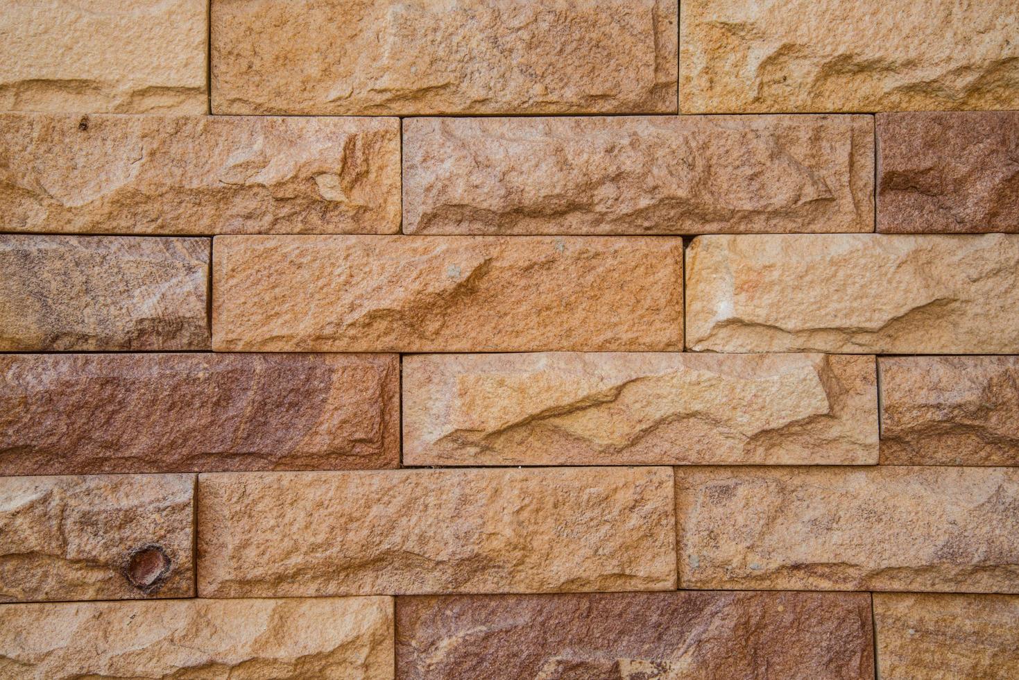 The granite stone brick wall textured background. photo