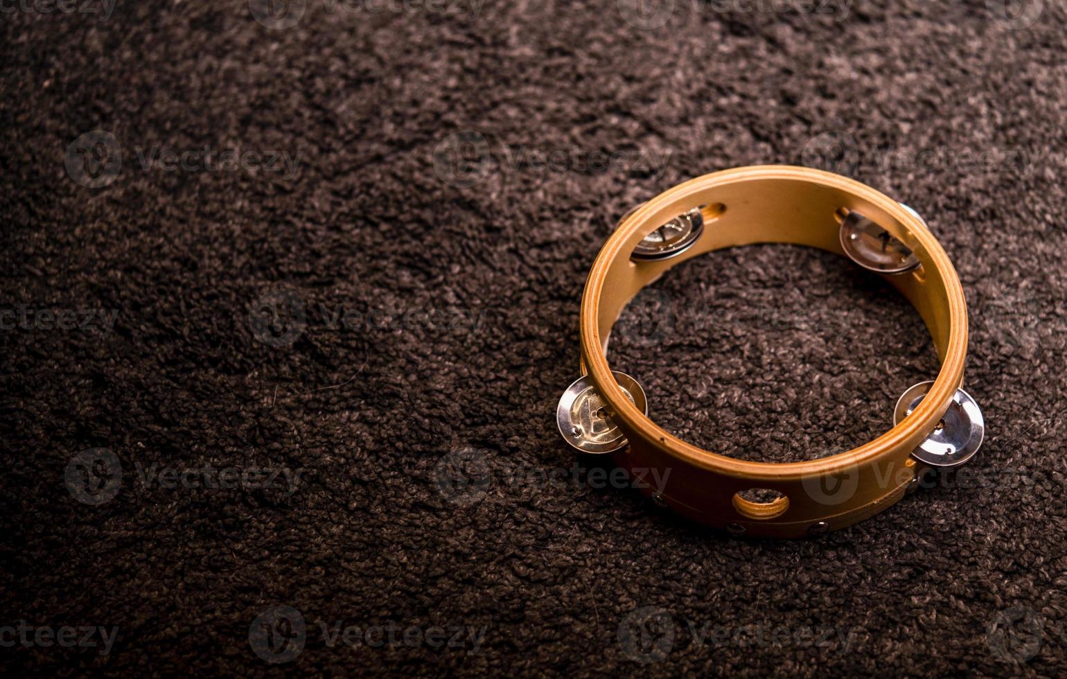 Tambourine isolated on brown background photo