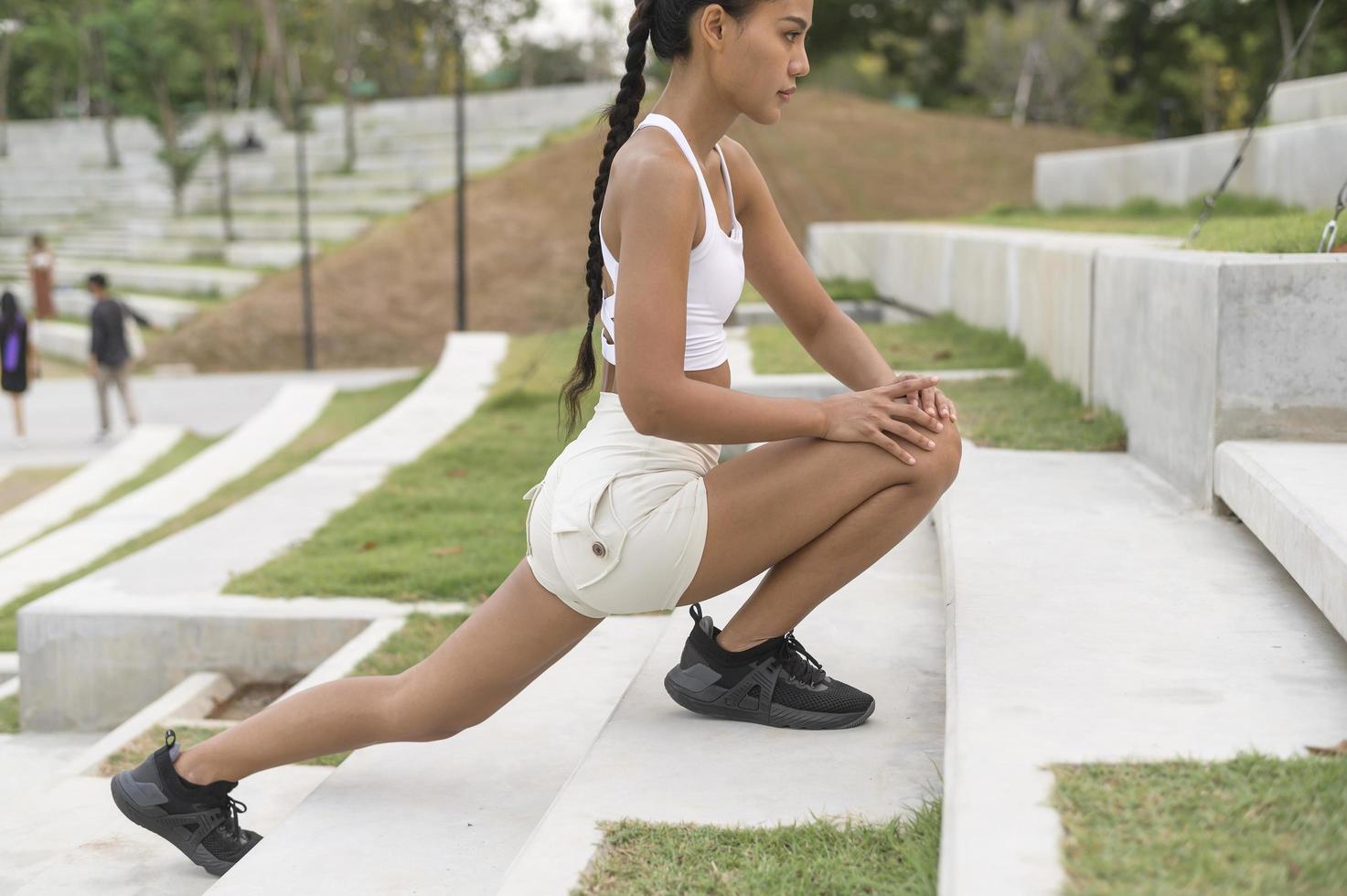 A young fitness woman in sportswear exercising in city park, Healthy and Lifestyles. photo