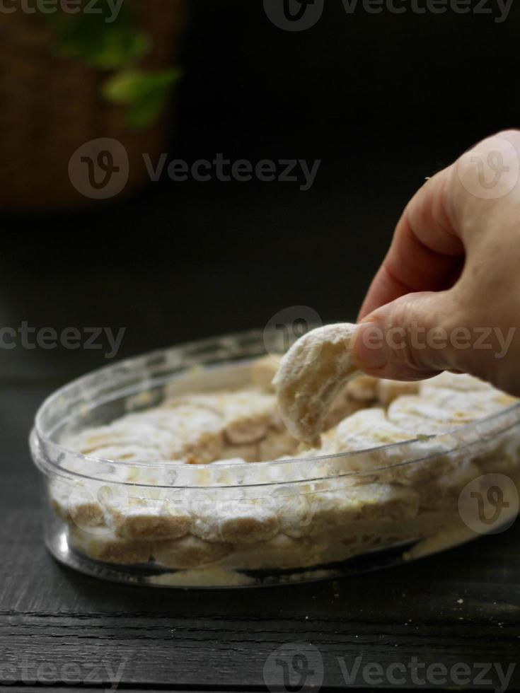 High angle view of hand in frame sweet snow cookies in low key photography photo