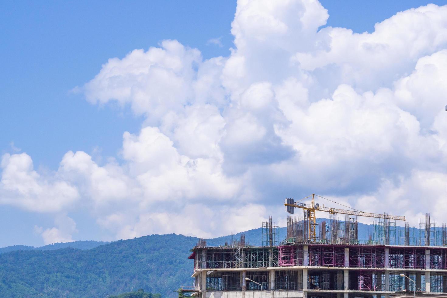 Yellow construction crane on the building photo