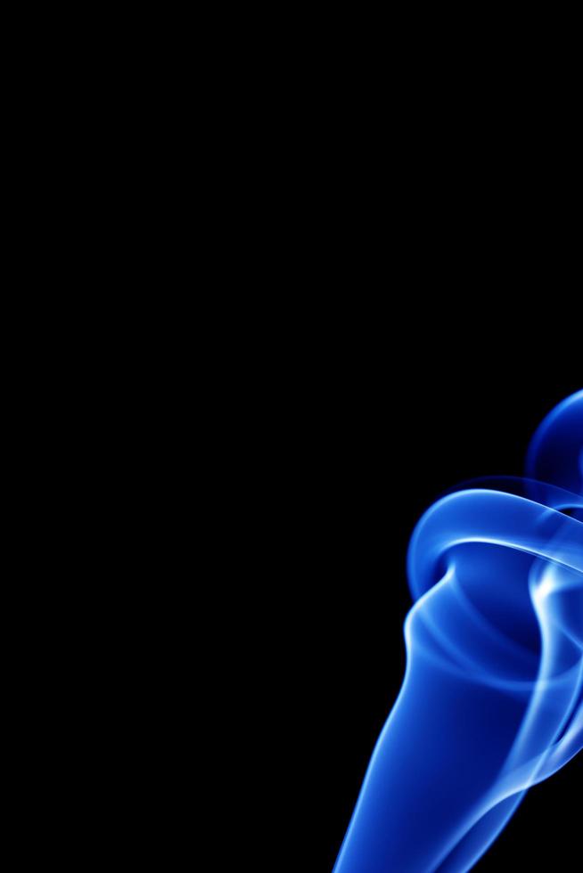 Blue smoke on black background photo