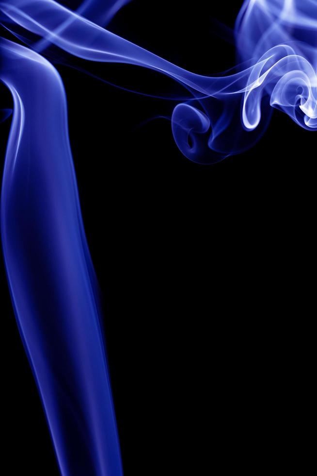 Blue smoke on black background photo