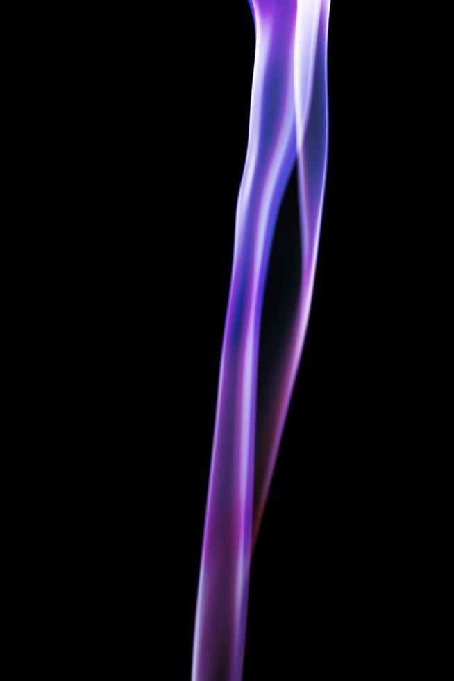 Purple smoke on black background photo