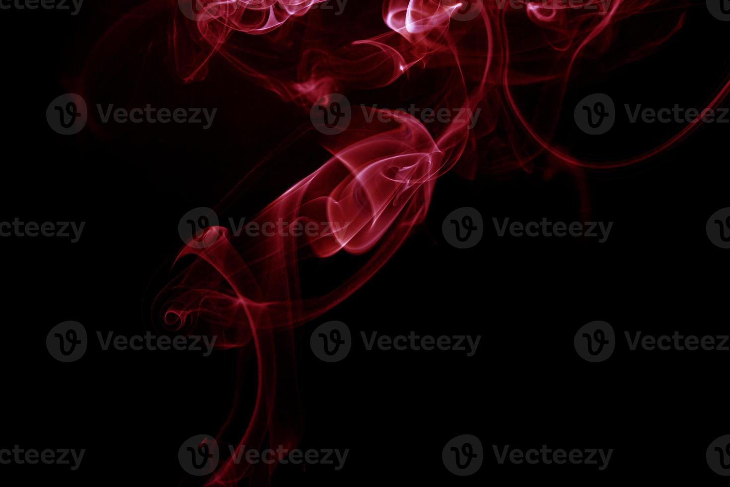 Red smoke on black background photo