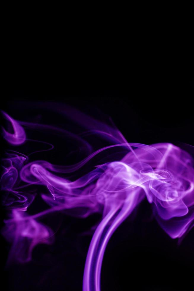 Purple smoke on black background photo