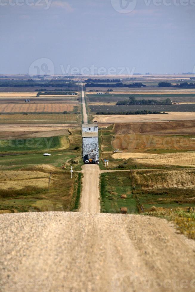 Grain elevator being moved along Saskatchewan country road photo