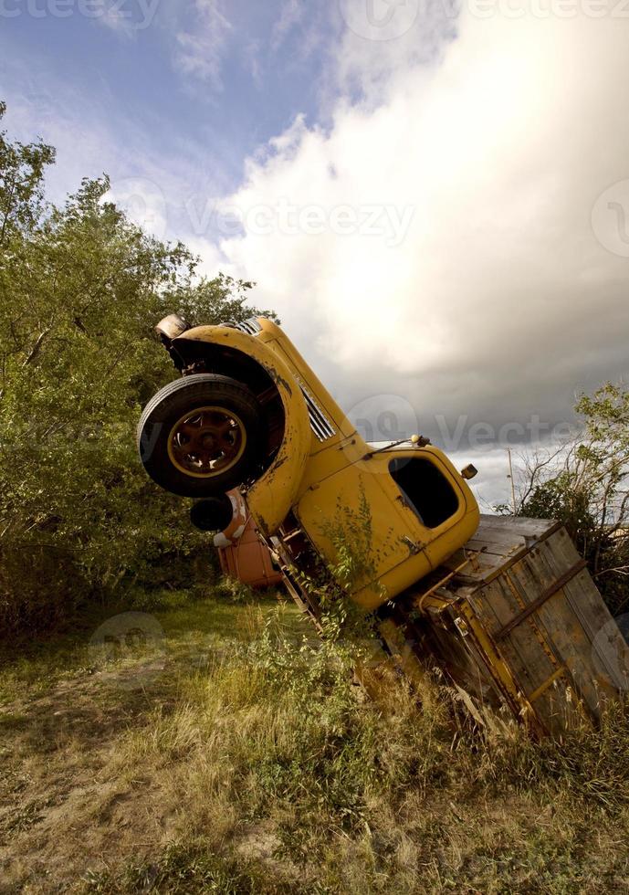 Antique truck sticking out of ground in Saskatchewan Canada photo