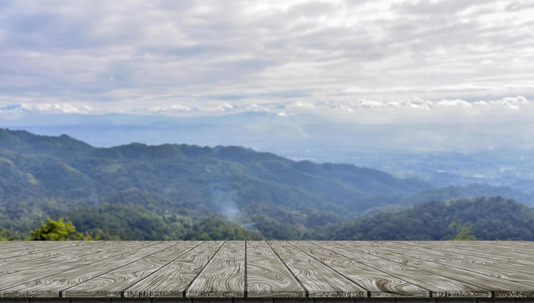 wooden table and beauty blur sky and mountains as background photo