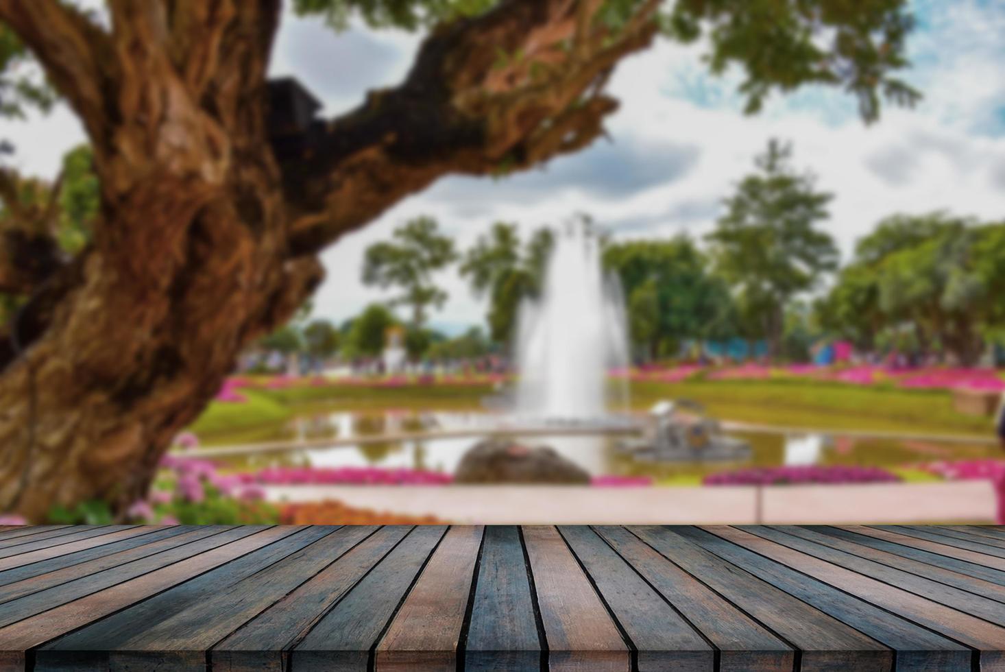 wooden table top on blurred park background photo