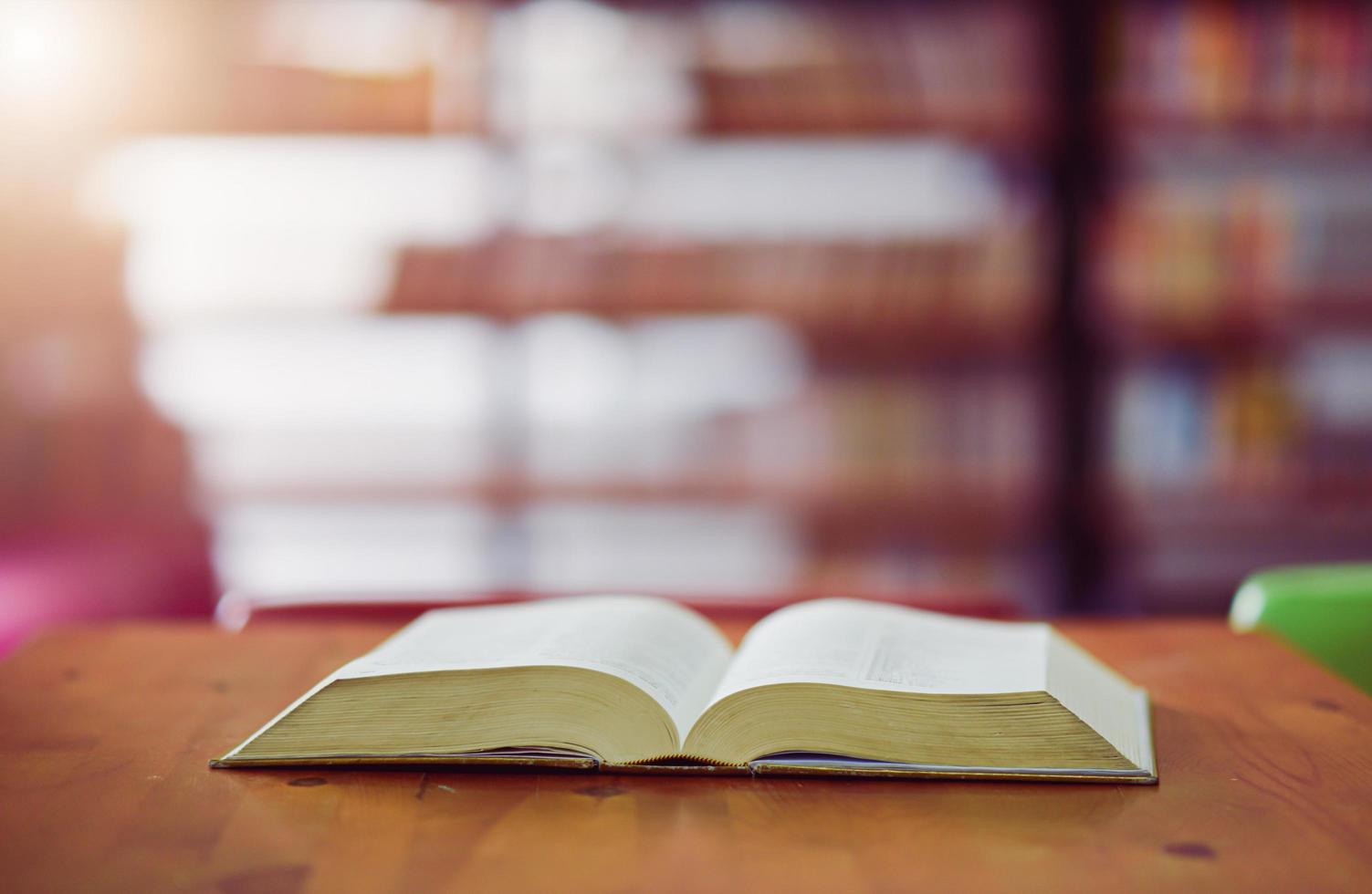 Open book on the table in library photo