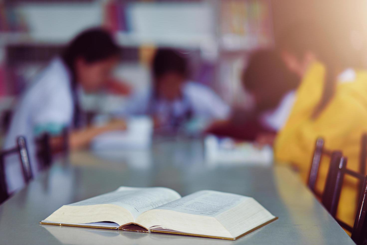 Open book on the table in library photo