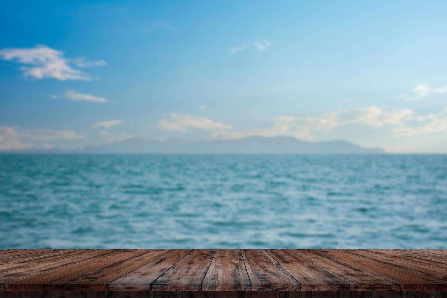 Wooden table tops on the sea floor in the hazy daylight. photo