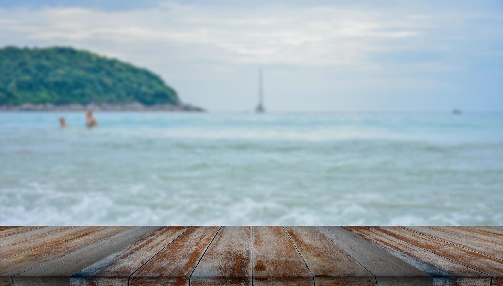 wooden table tops on the blurry sea floor photo