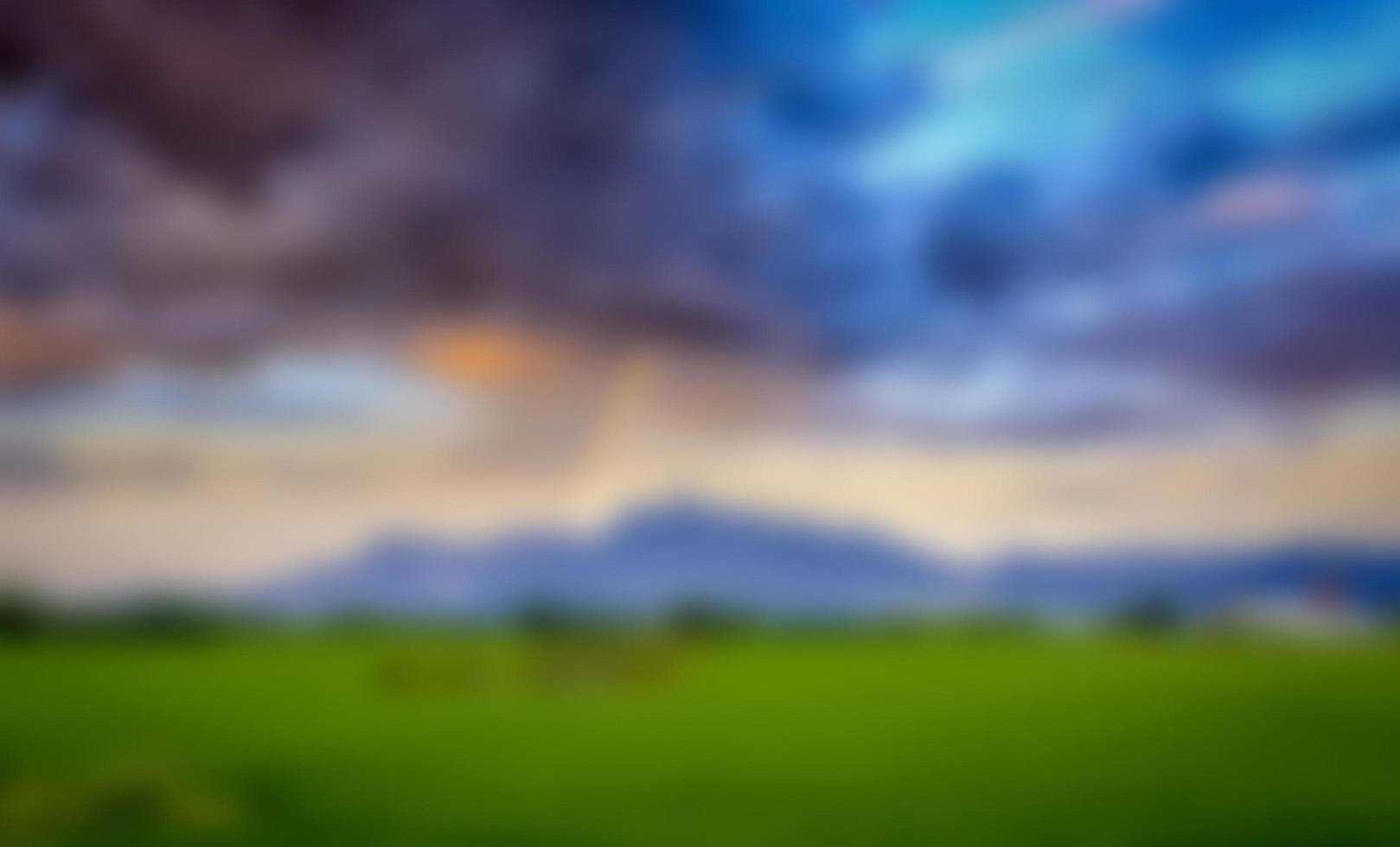The blurred view of the mountains against the beautiful backdrop of the colored sky and clouds. photo