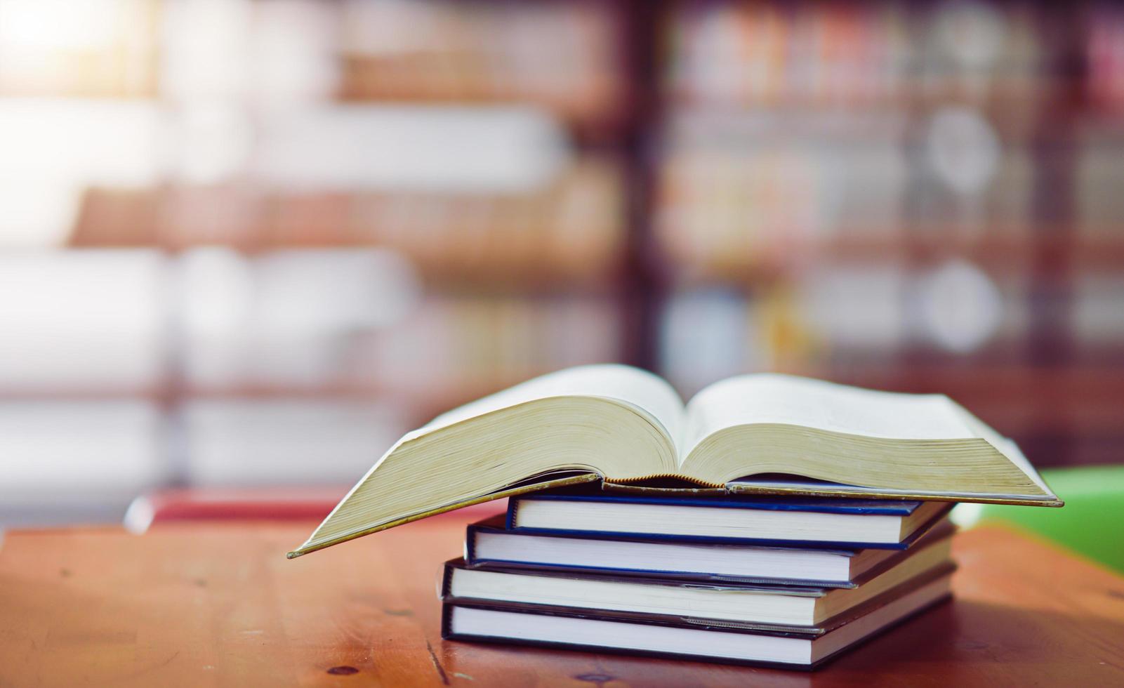 Open book on the table in library photo