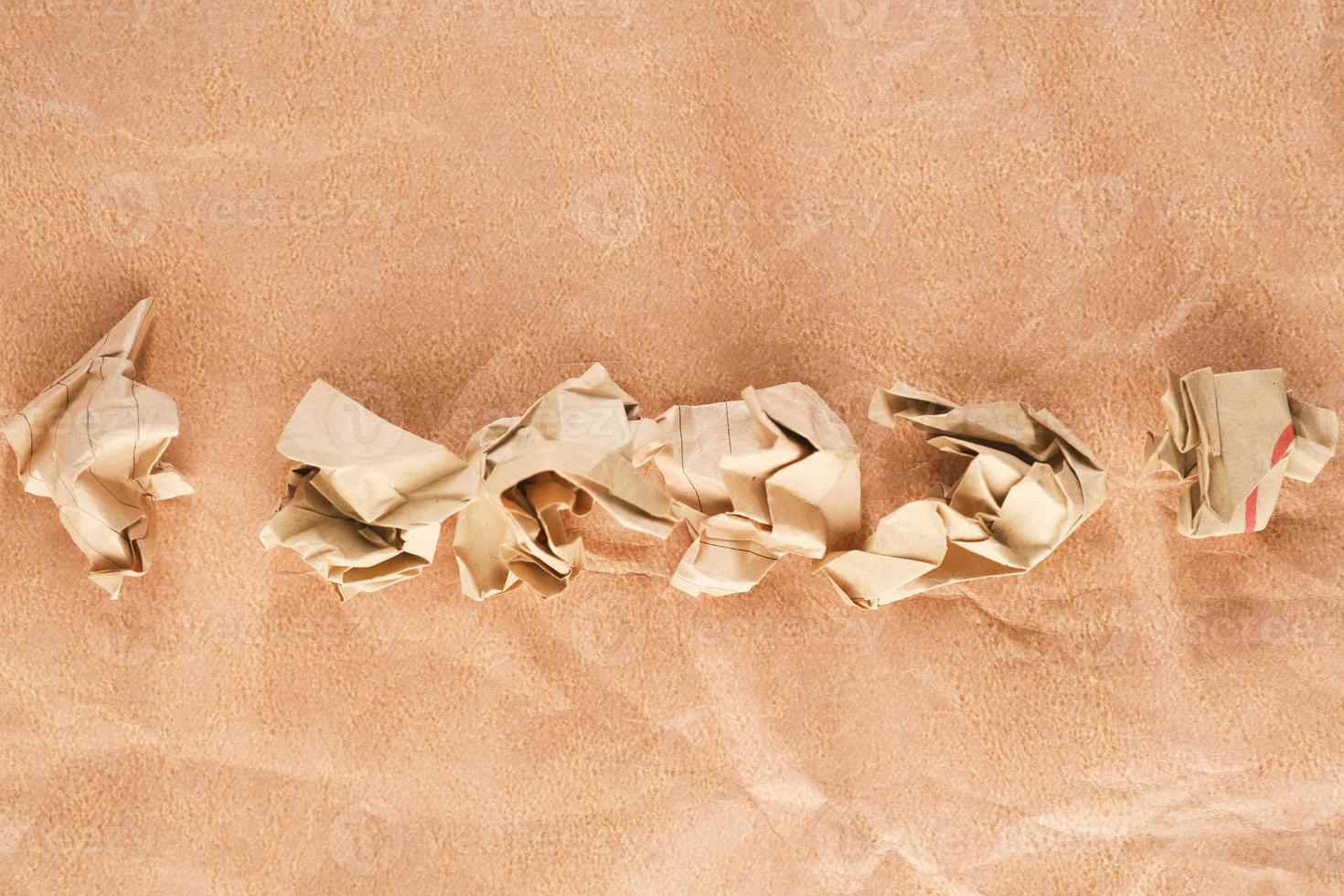 top view of crumpled paper balls on old paper photo