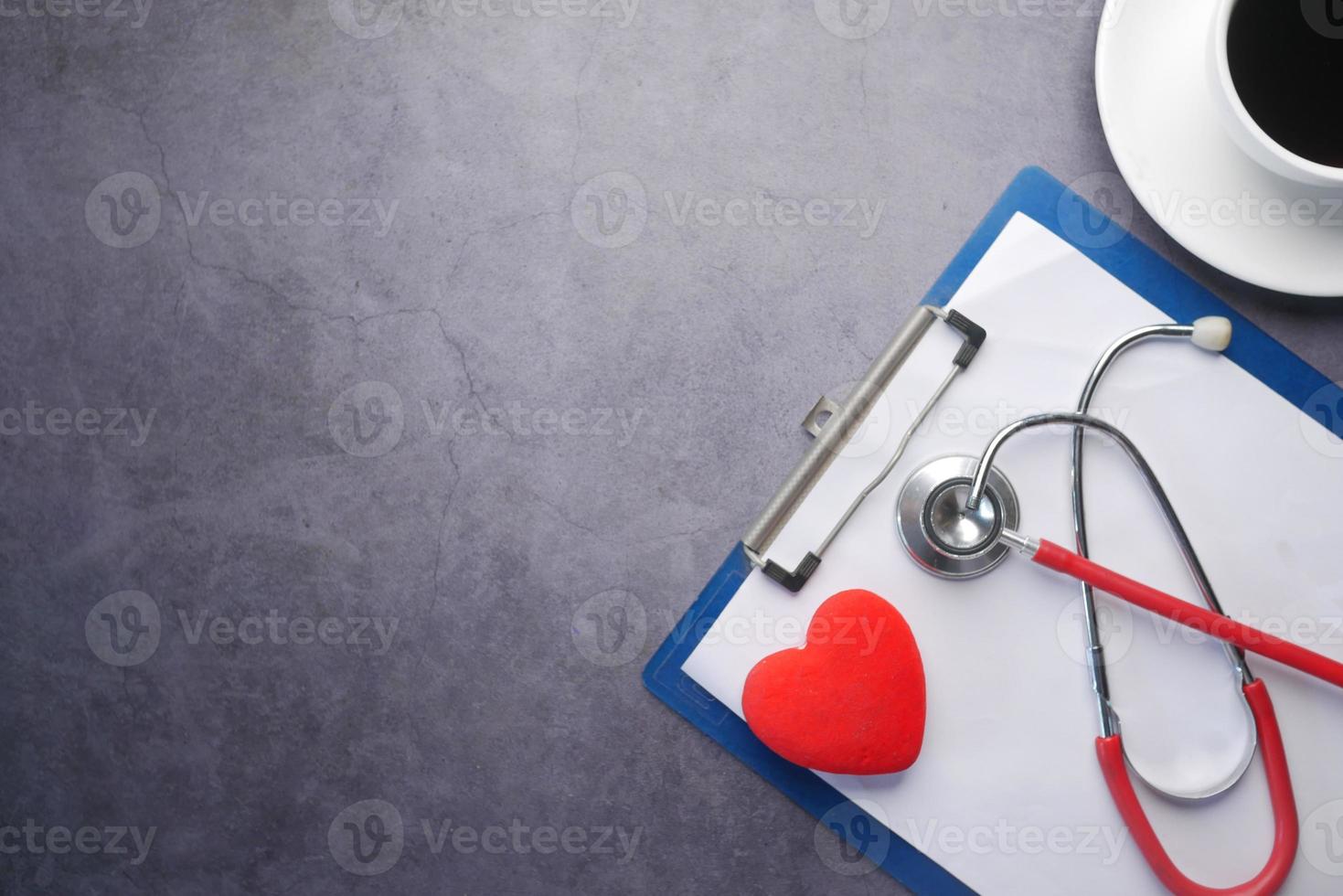 high angle view of pills , keyboard and stethoscope on clinic desk . photo