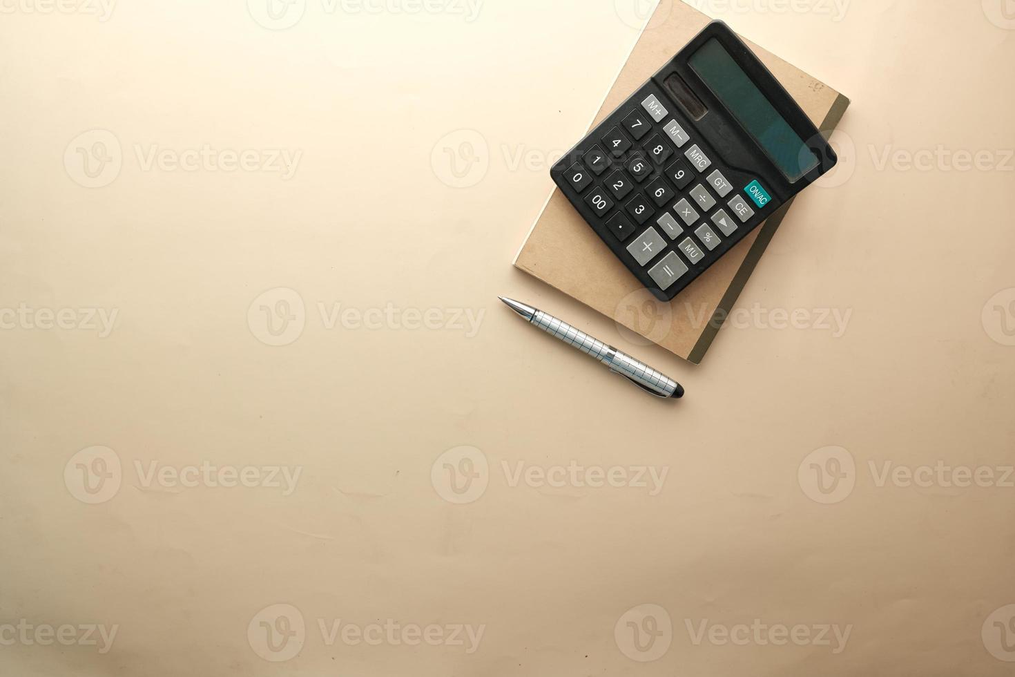 top view of calculator and notepad on color background photo