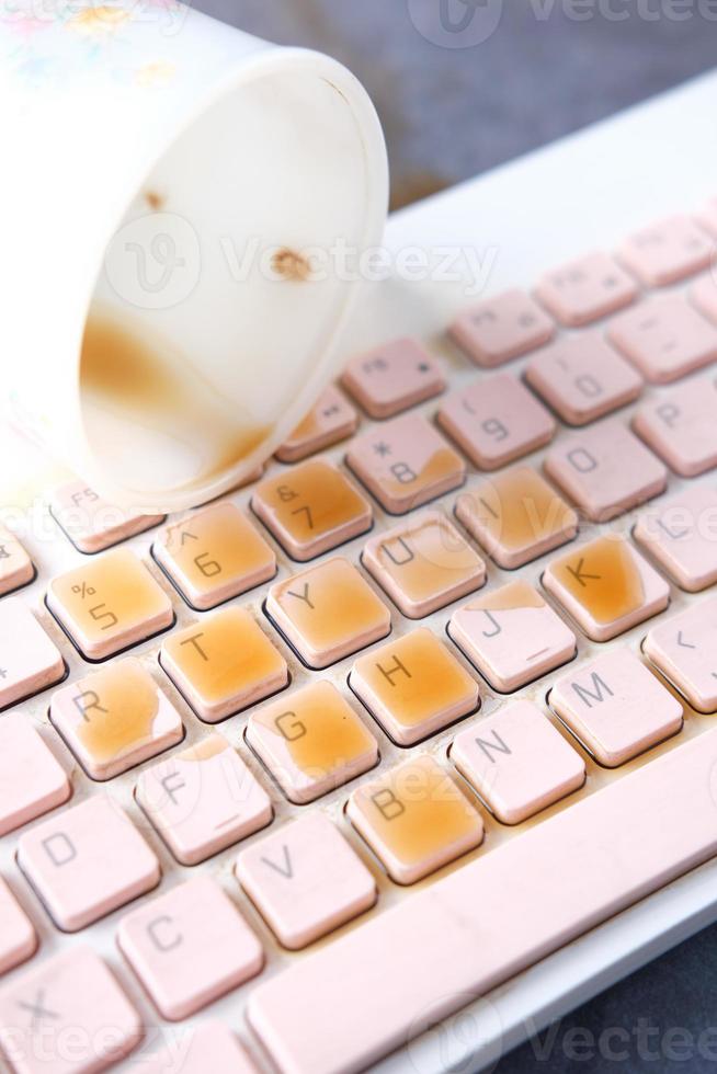 coffee spilling on laptop keyboard. close up photo