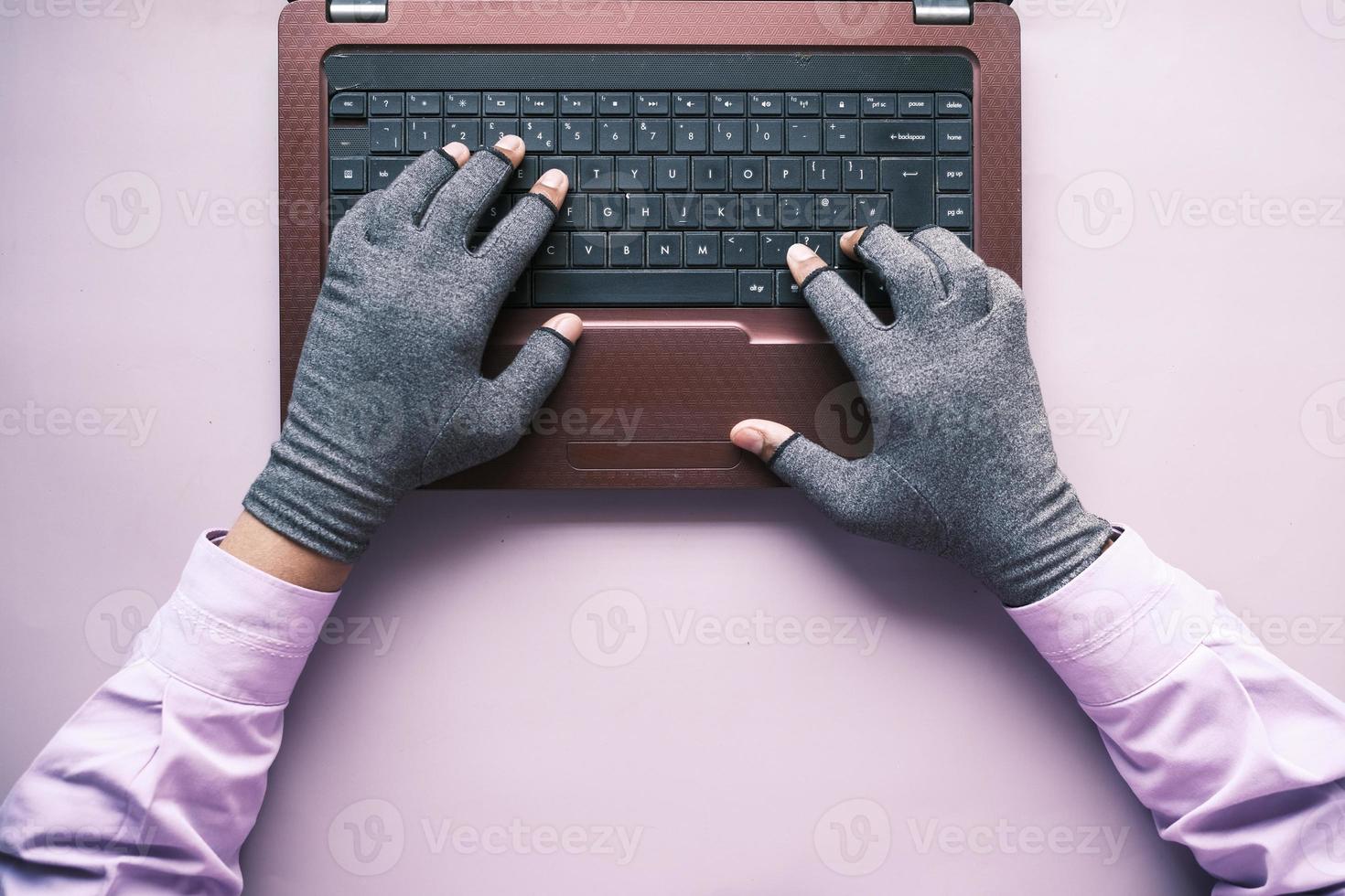 hacker hand stealing data from laptop top down photo