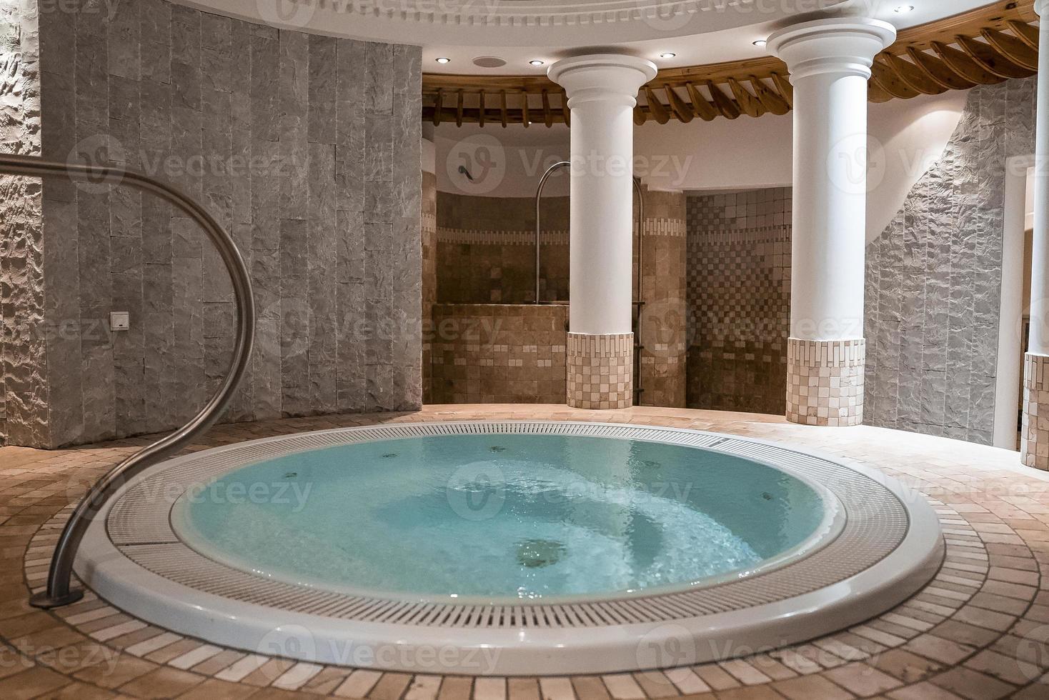 Round jacuzzi in modern bathroom with elegant style in luxurious ski resort photo