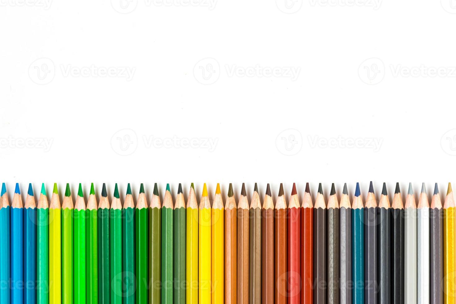 Multi-colored wooden sticks Wooden colouring pencils on white background photo