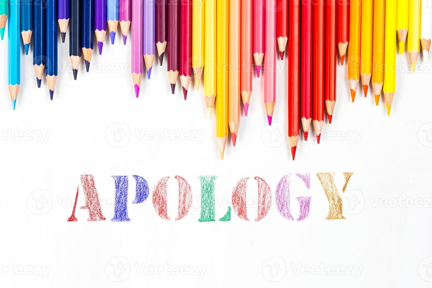 Multi-colored wooden sticks Wooden colouring pencils and apology on white background photo