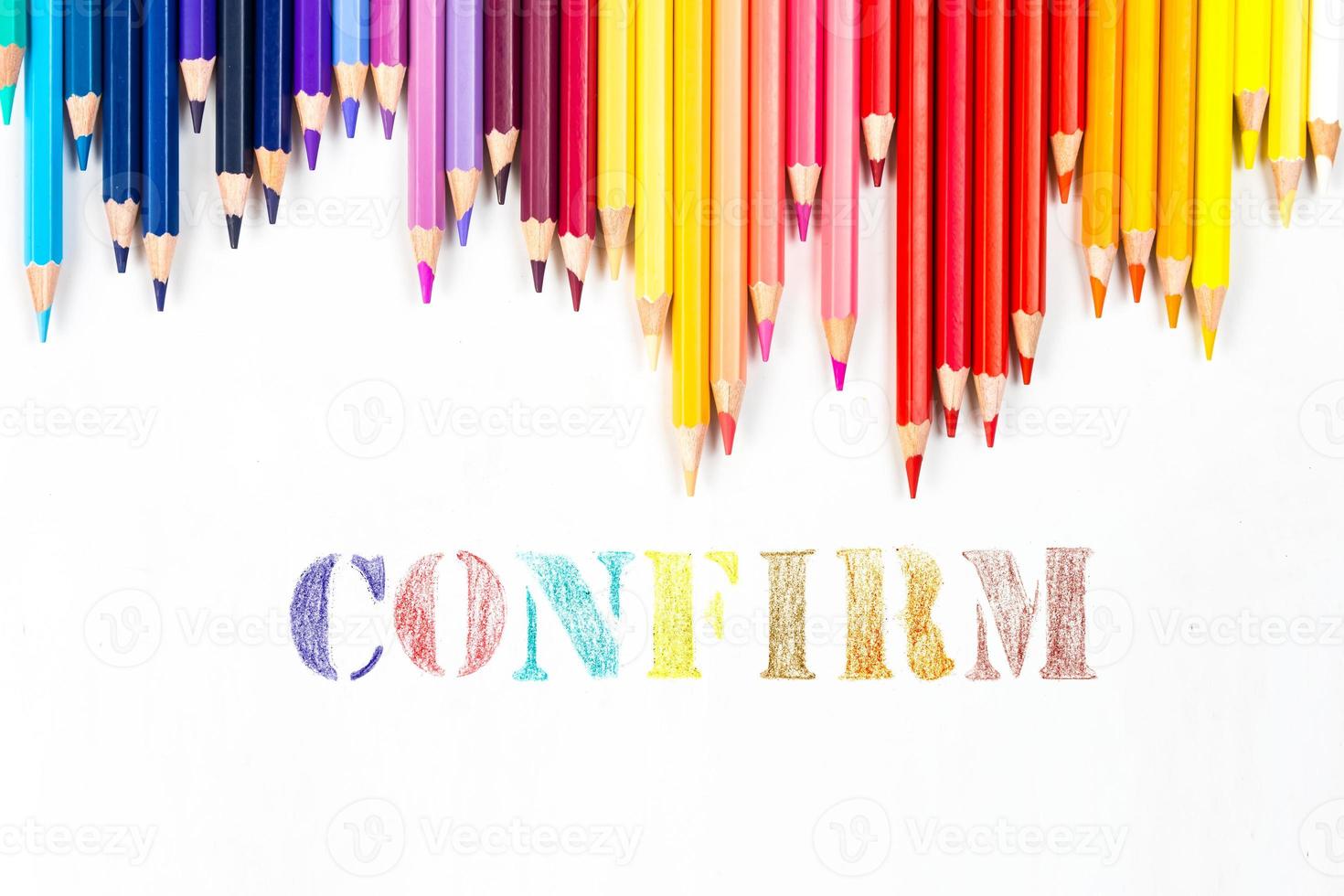 Multi-colored wooden sticks Wooden colouring pencils and Confirm on white background photo