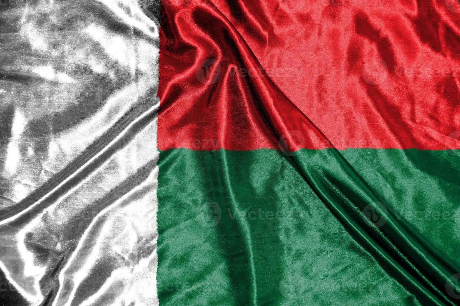 bandera de tela de madagascar bandera de raso ondeando la textura de la tela de la bandera foto