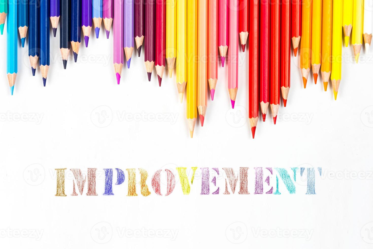 Multi-colored wooden sticks Wooden colouring pencils and Improvement on white background photo