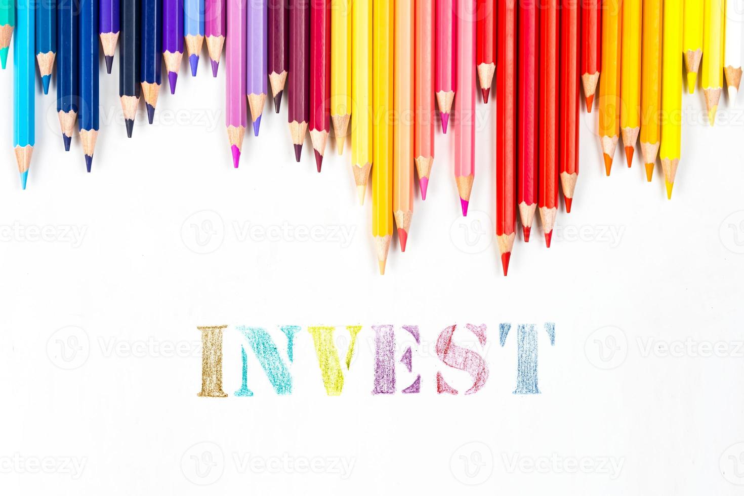 Multi-colored wooden sticks Wooden colouring pencils and invest on white background photo