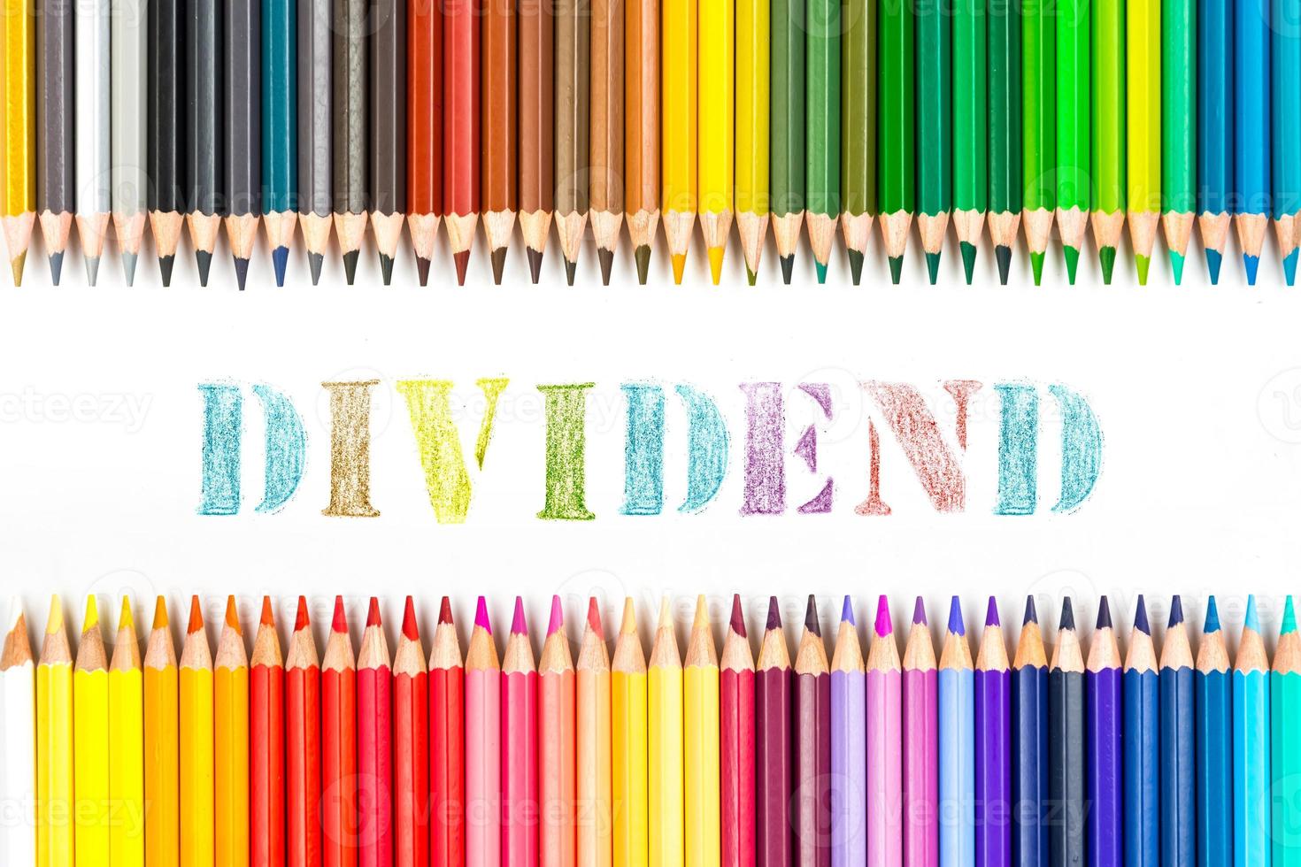 Multi-colored wooden sticks Wooden colouring pencils and dividend on white background photo