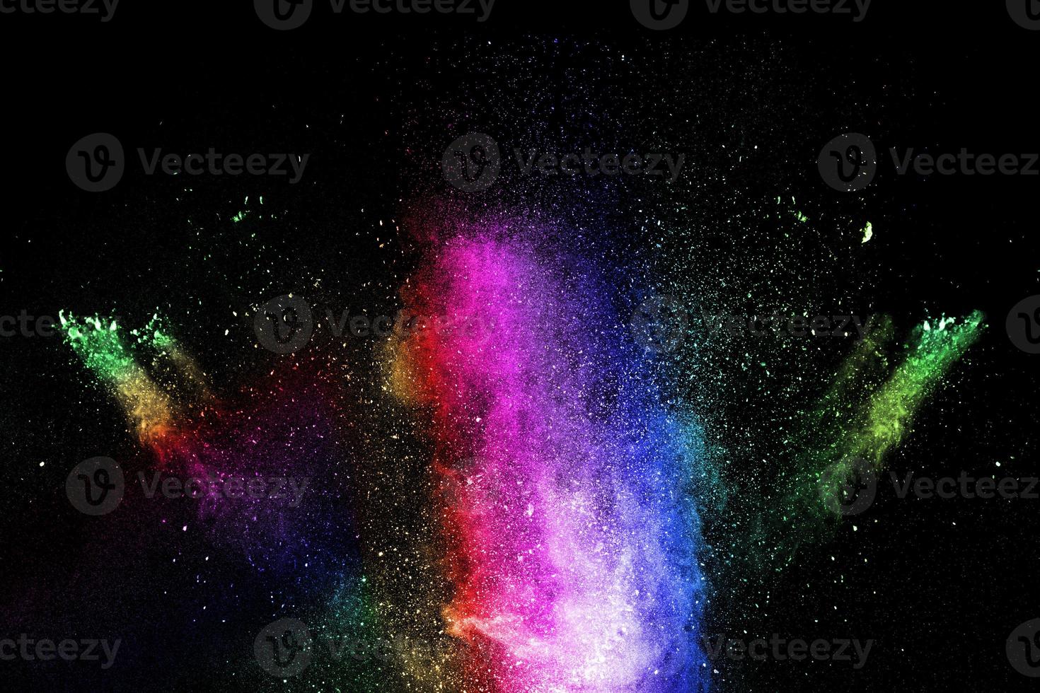 Launched multicolored powder on black background.Color powder explosion.Colorful dust splashing. photo