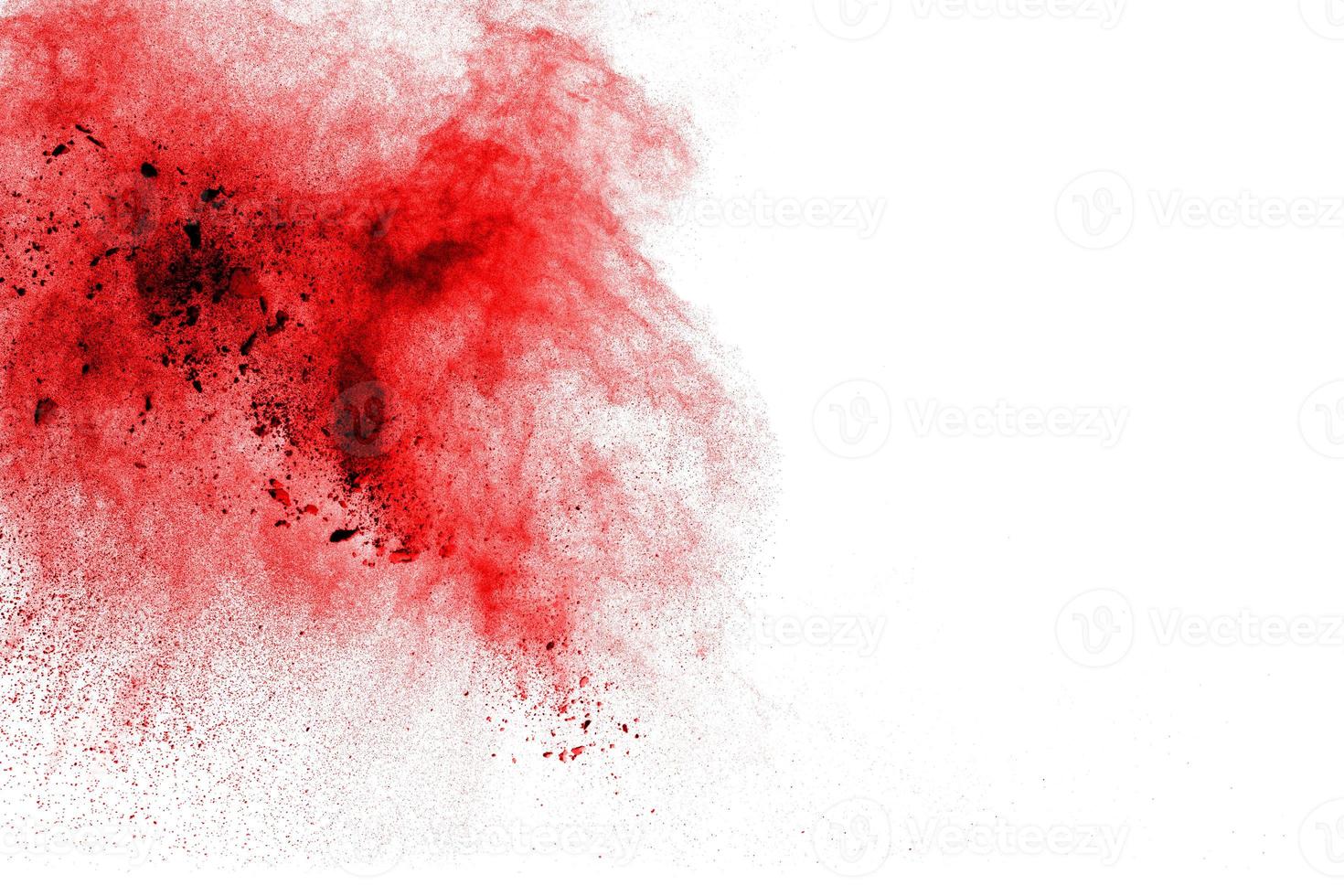 Abstract red dust explosion on white background. Freeze motion of red powder splash. photo