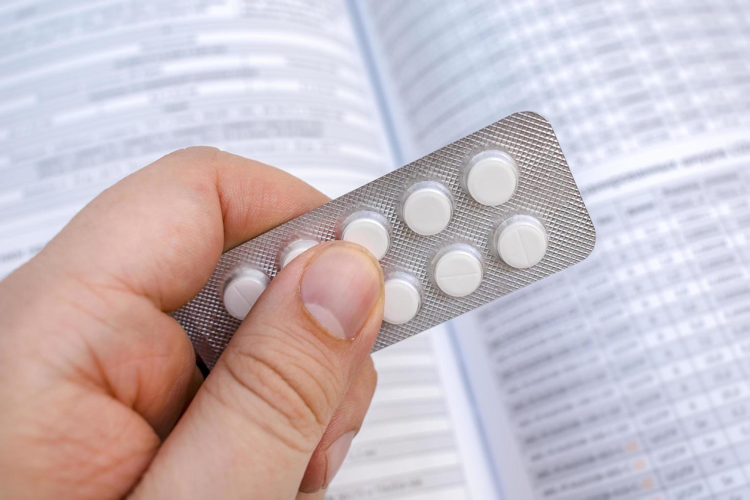 Packing tablets in the hands of a patient or doctor. Medications for treating patients in a pharmacy photo