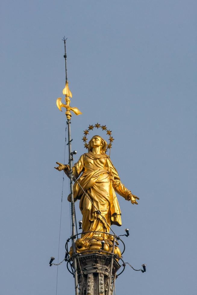 MILAN, ITALY, 2008. Statue of Madunina on top of the Duomo photo