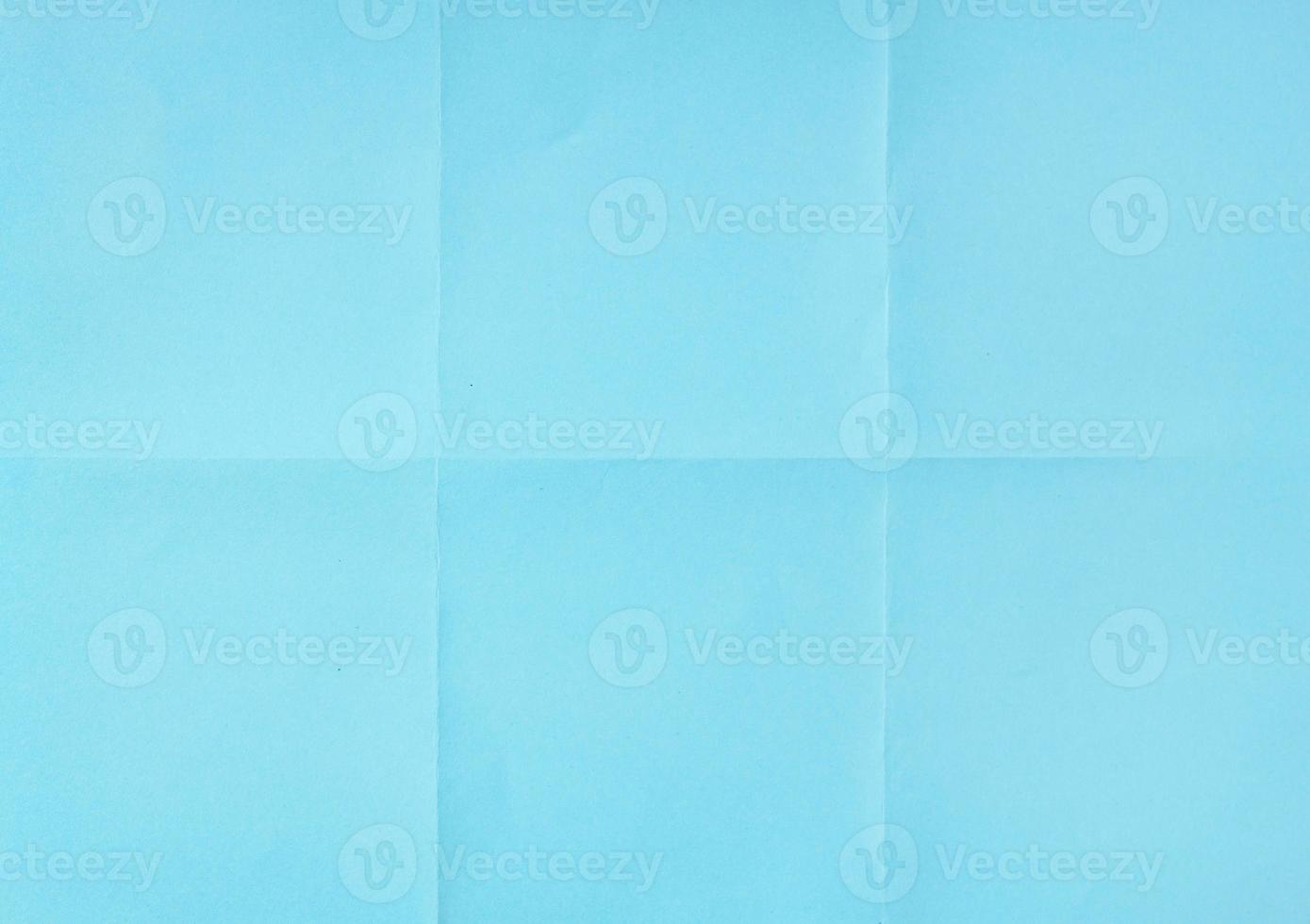 Blue crumpled unfolded paper sheet texture background. Paper folded in six. Full frame photo