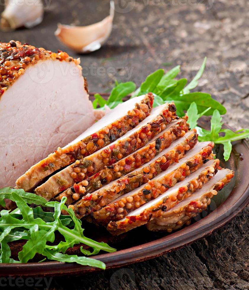 Baked pork decorated with arugula leaves photo